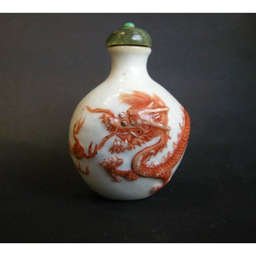 Snuff bottle porcelain with a low relief a Dragon in iron red